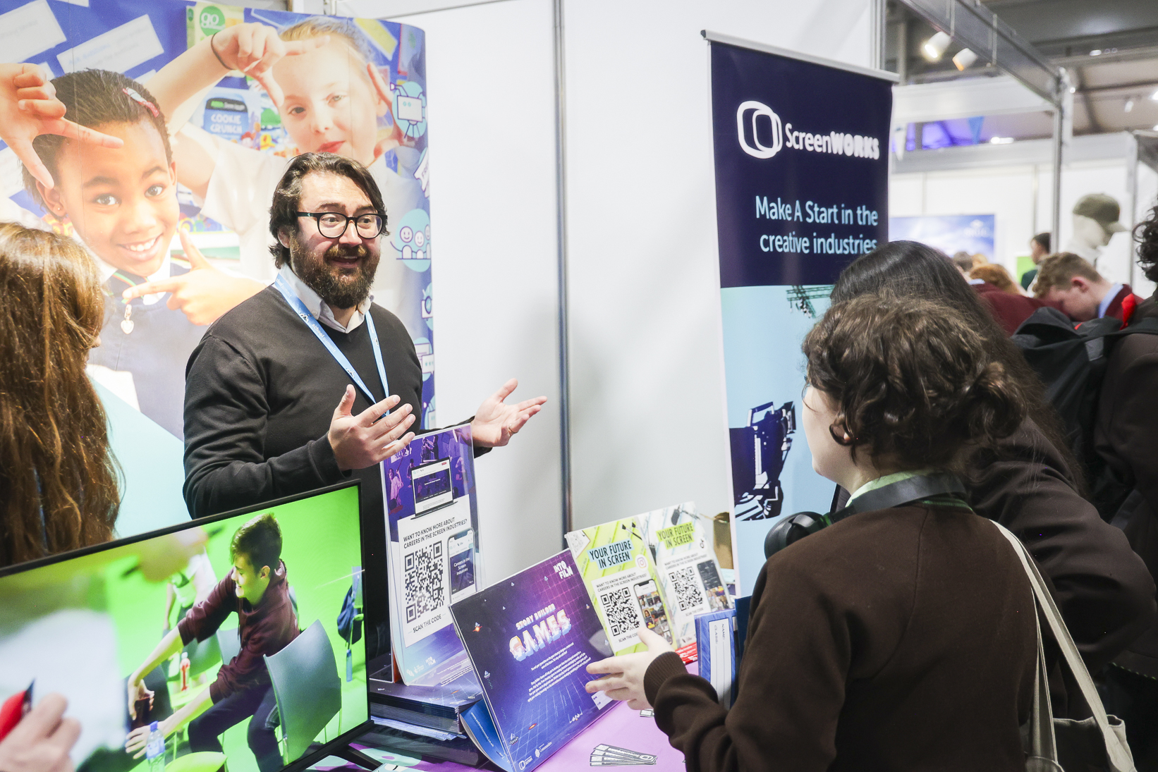 Pupils and exhibitors engaged on the School Summit Northern Ireland exhibition floor, 2024.