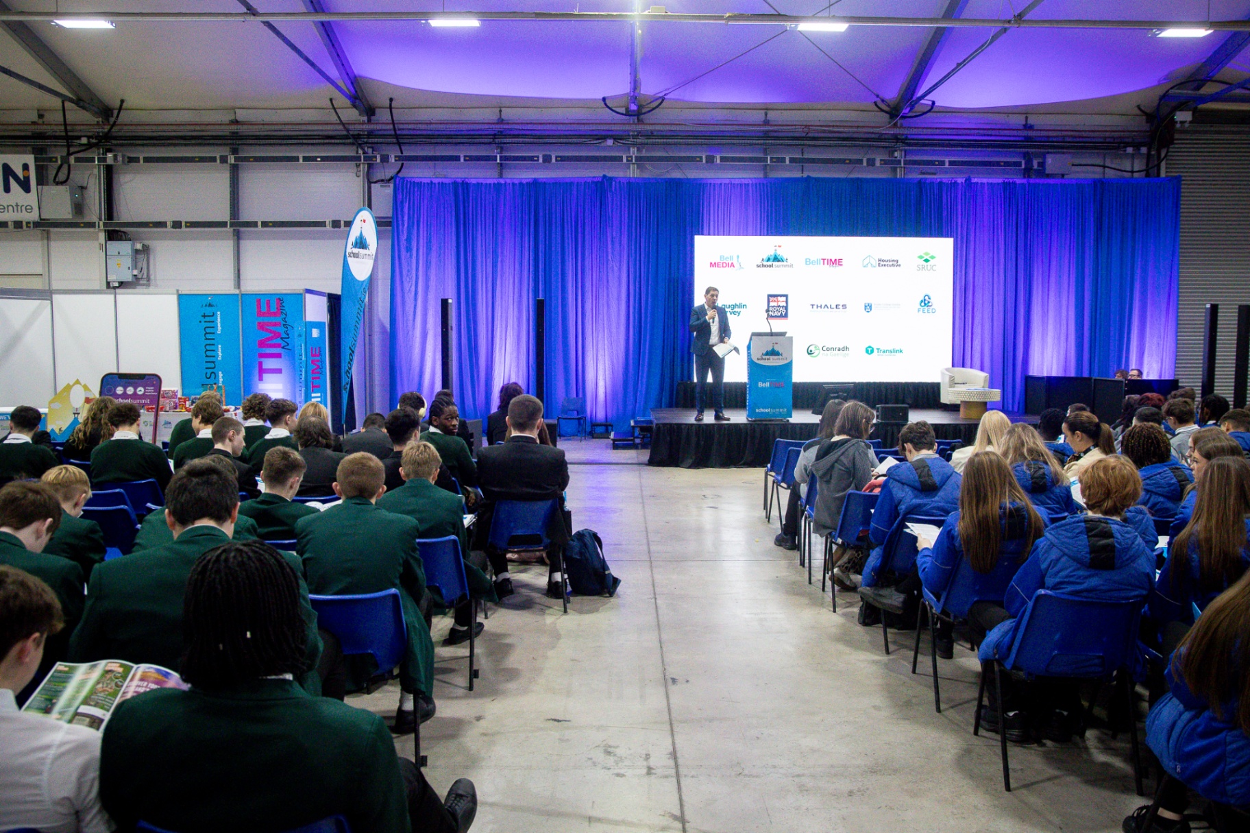 A British Army officer wearing a beret speaking with a secondary-school pupil at School Summit Northern Ireland.