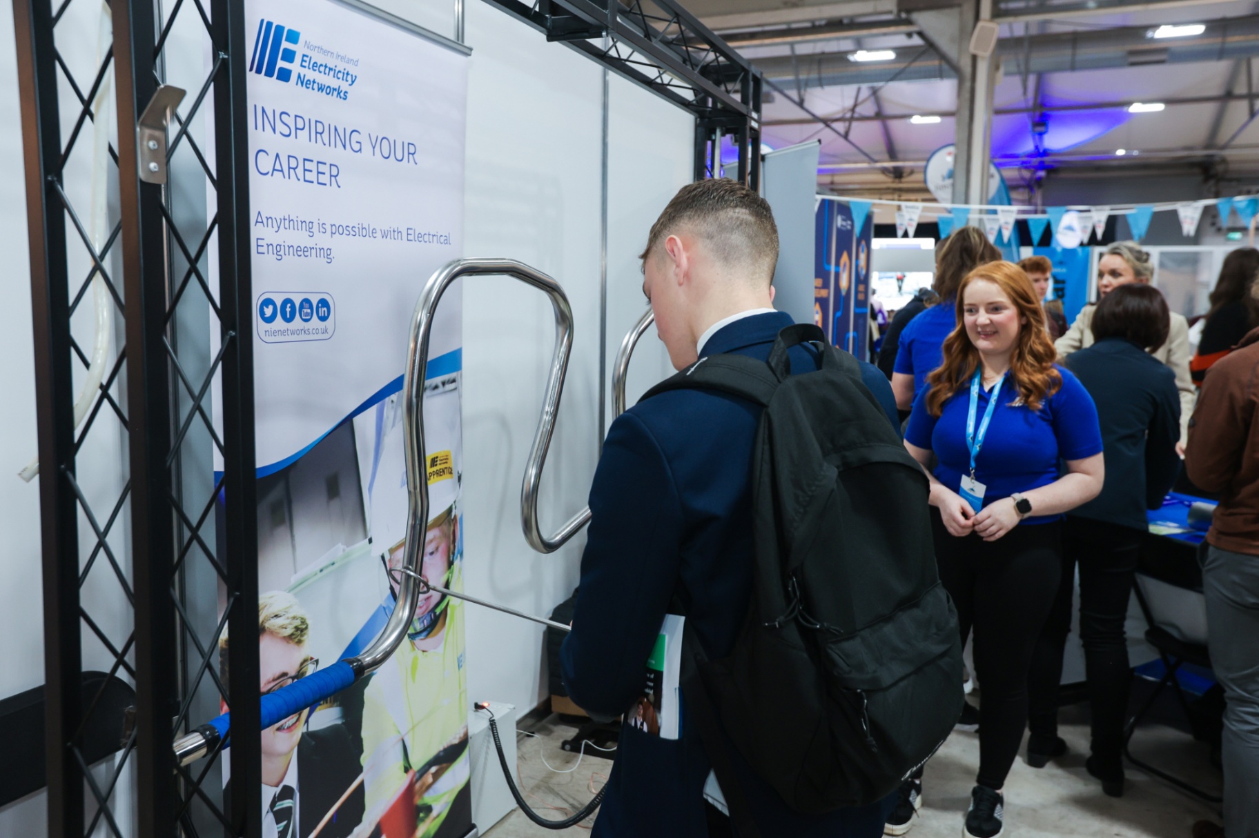 A pupil handling training equipment at the NIE Networks ‘Empowering Your Career’ branded exhibitor stand at School Summit Northern Ireland, 2022.